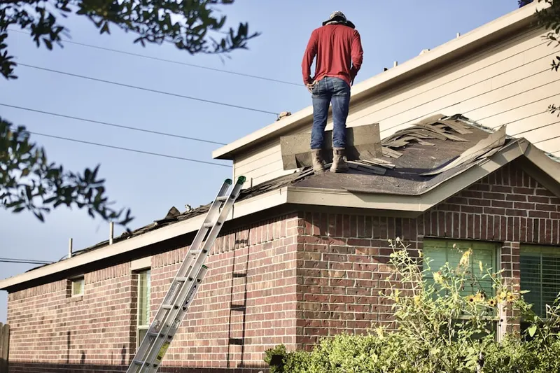 Professional roofer working on a residential roof in North Lewisburg
